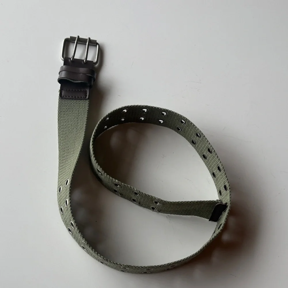 Olive Green Canvas Belt with brown accents. Silver tone hook loops.